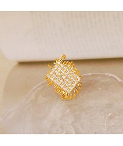 Macro shot of gold weave ring with sparkling pave cubic zirconia setting on textured tray