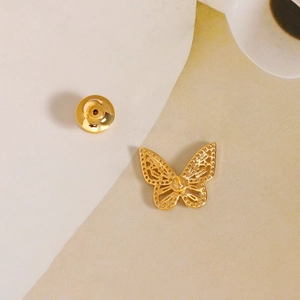 Exquisite goldene Schmetterlingsbrosche mit durchbrochenen Flügeln auf hellem Grund