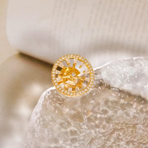 Luxurious gold geometric brooch with intricate mechanical gear design and white zircons