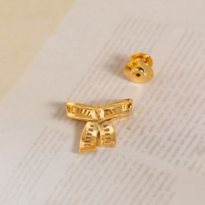 Elegant gold bow brooch with hollow zircon design and butterfly pin backing for scarves