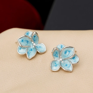 Vintage enamel floral stud earrings with blue oil painting texture and pearl centers