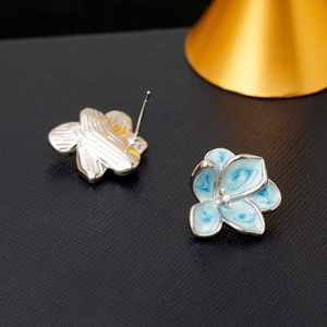 Elegant blue enamel flower stud earrings with silver edges and marble texture