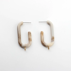 Detail of U-shaped marble resin earrings with gold loop for DIY jewelry making