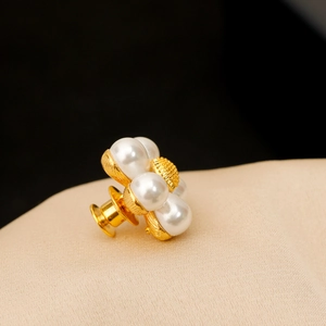 Broche fleur marguerite en perles avec finition dorée sur tissu en soie beige