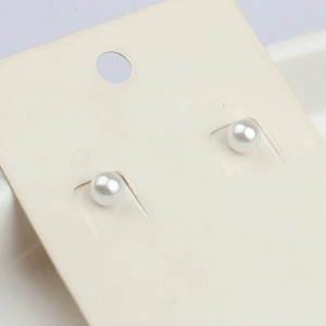 Boucles d'oreilles perles blanches 6mm classiques sur carte de présentation