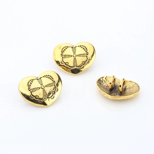 Detail of vintage heart alloy buttons with antique gold plating and back dual holes