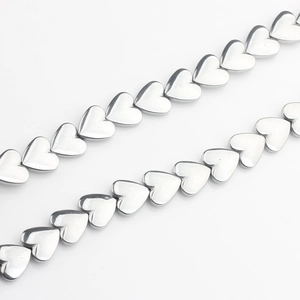 Detailed view of silver heart-shaped hematite beads for DIY jewelry making and crafts