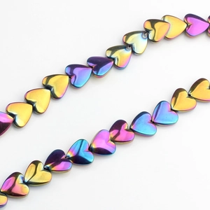 Macro view of 10mm iridescent hematite heart beads for DIY jewelry making