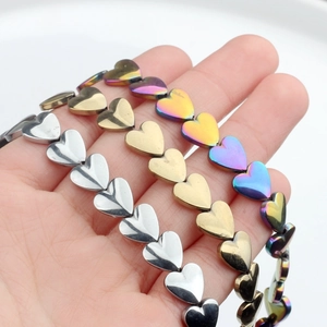 Polished 10mm hematite heart beads in silver, gold, and iridescent finishes for DIY jewelry