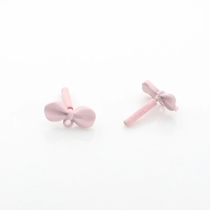 Close-up of pink bow alloy earring components with matte finish and connector loops