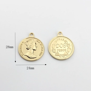 Macro view of vintage gold coin pendants with Queen Elizabeth II relief for DIY earrings