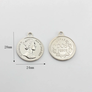 Detail of silver coin pendants showing Queen Elizabeth II portrait and floral wreath back