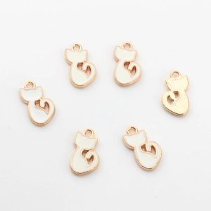 Detailed view of six white enamel cat charms with gold alloy plating for DIY jewelry making