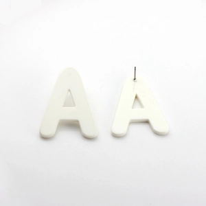 Detail view showing white acrylic letter A stud earrings with front and back pin structure