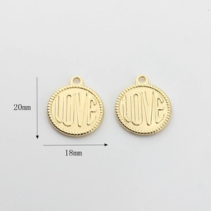 Macro view of gold round metal pendant with LOVE letter embossing and 20mm height detail