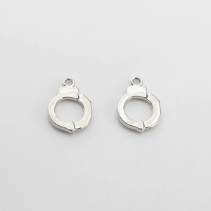 Detailed view of silver handcuff-shaped metal charms for DIY necklace and bracelet jewelry making
