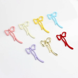Detailed view of colorful alloy bow pendants for DIY jewelry and earring making