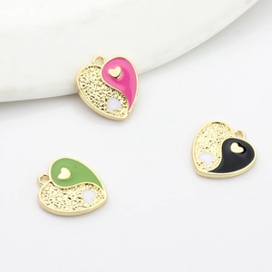 Colorful yin-yang heart pendants in pink, green, and black for DIY jewelry making