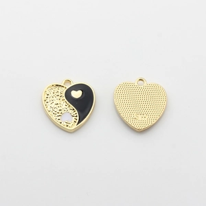 Macro view of heart-shaped yin yang alloy pendant with gold plating and SW engraved mark