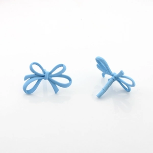 Macro detail of light blue matte bow stud earrings with a smooth spray paint finish