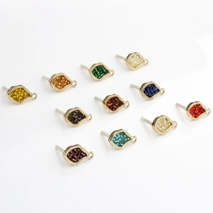 Detail of colorful beaded alloy geometric pendants with gold-plated earring hooks