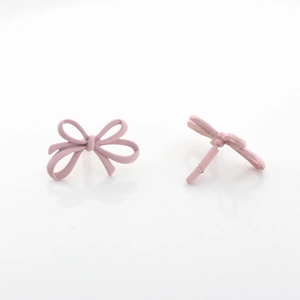 Detailed view of pink matte bow stud earrings made of high quality painted alloy