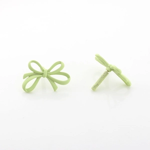 Detail view of matte light green bow stud earrings with alloy spray paint finish