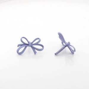Macro view of matte light purple bow stud earrings with a minimalist knotted design