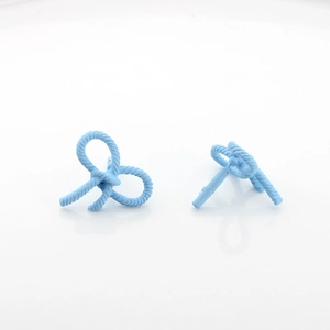 Detail of light blue bow stud earrings with twisted rope texture and matte finish