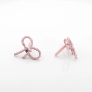 Close-up of pink matte bow earrings featuring a textured twisted rope design on white