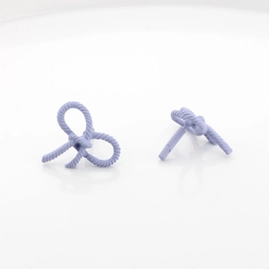 Detail of lavender purple matte bow earrings featuring twisted rope texture on white background