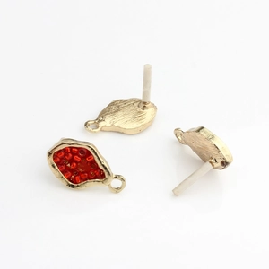 Detailed view of DIY geometric gold earring base with red beads and ear pins