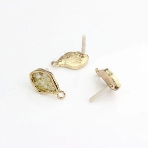 Detailed view of gold plated geometric jewelry components with seed beads for DIY earrings