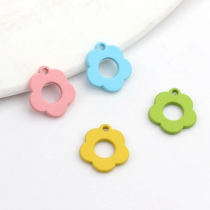 Set of four colorful matte alloy hollow flower charms in pink, blue, yellow, and green