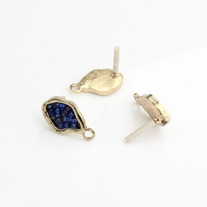 Detail of teardrop gold-plated alloy earring studs with navy blue beads and hanging loops