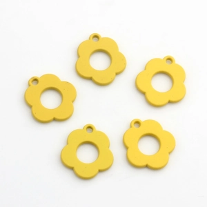 Macro shot of 5 yellow matte flower alloy charms for DIY jewelry making and crafts