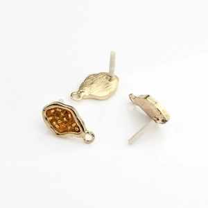 Macro view of gold-plated alloy irregular leaf earring stud with bead details for DIY