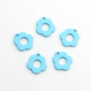 Macro view of 5 light blue hollow flower pendants for DIY jewelry making accessories