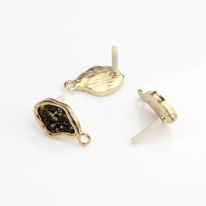 Macro detail of irregular gold leaf-shaped DIY earring bases with dark grey micro beads