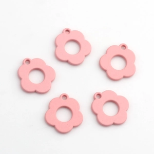 Close-up of five matte pink hollow flower alloy charms for DIY jewelry making