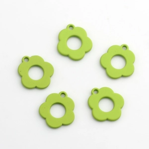Detailed view of light green flower pendants with a hollow center and matte finish