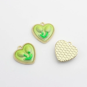 Gros plan de pendentifs tulipes en forme de cœur en émail vert pour bijoux DIY