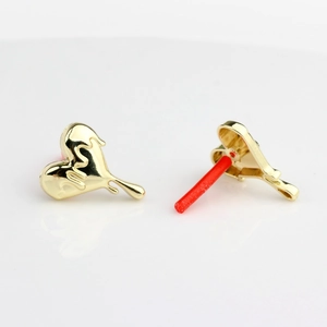 Macro shot of gold liquid lava heart stud earrings with artistic melting texture