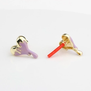 Macro shot of purple drip oil heart earrings with gold alloy and protective needle caps
