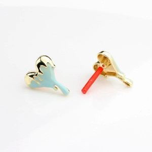 Detail view of drip oil heart earrings with golden lava texture and light blue finish