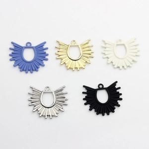 Five geometric hollow sunburst pendant charms in gold, silver, blue, white, and black finish