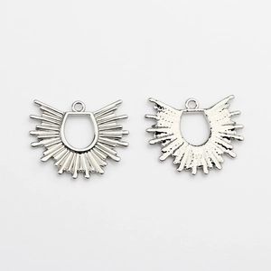 Detailed close-up showing the front and back texture of silver sunburst fan charms