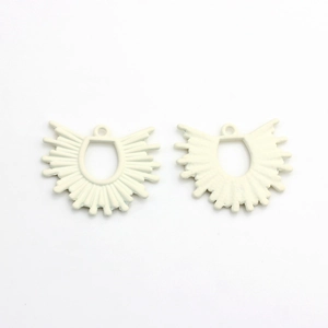 Macro detail of white fan-shaped geometric alloy charms for DIY jewelry making and earrings