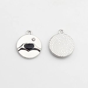 Front and back detail of alloy heart charm with black inlay and crystal accent