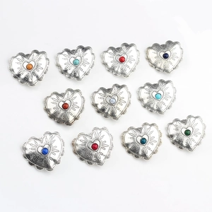 Detailed view of vintage heart-shaped alloy buttons with colorful stone inlays